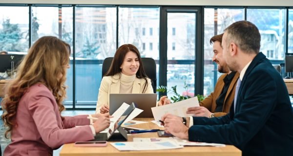 Business meeting in an office, workers discussing business affairs. Gadgets and papers on the table
